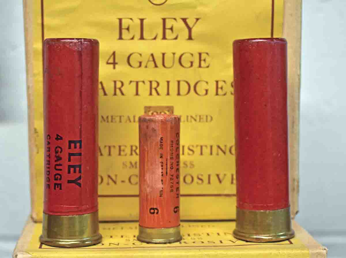 A 12-bore shotshell bracketed by a pair of 4-bore shells.